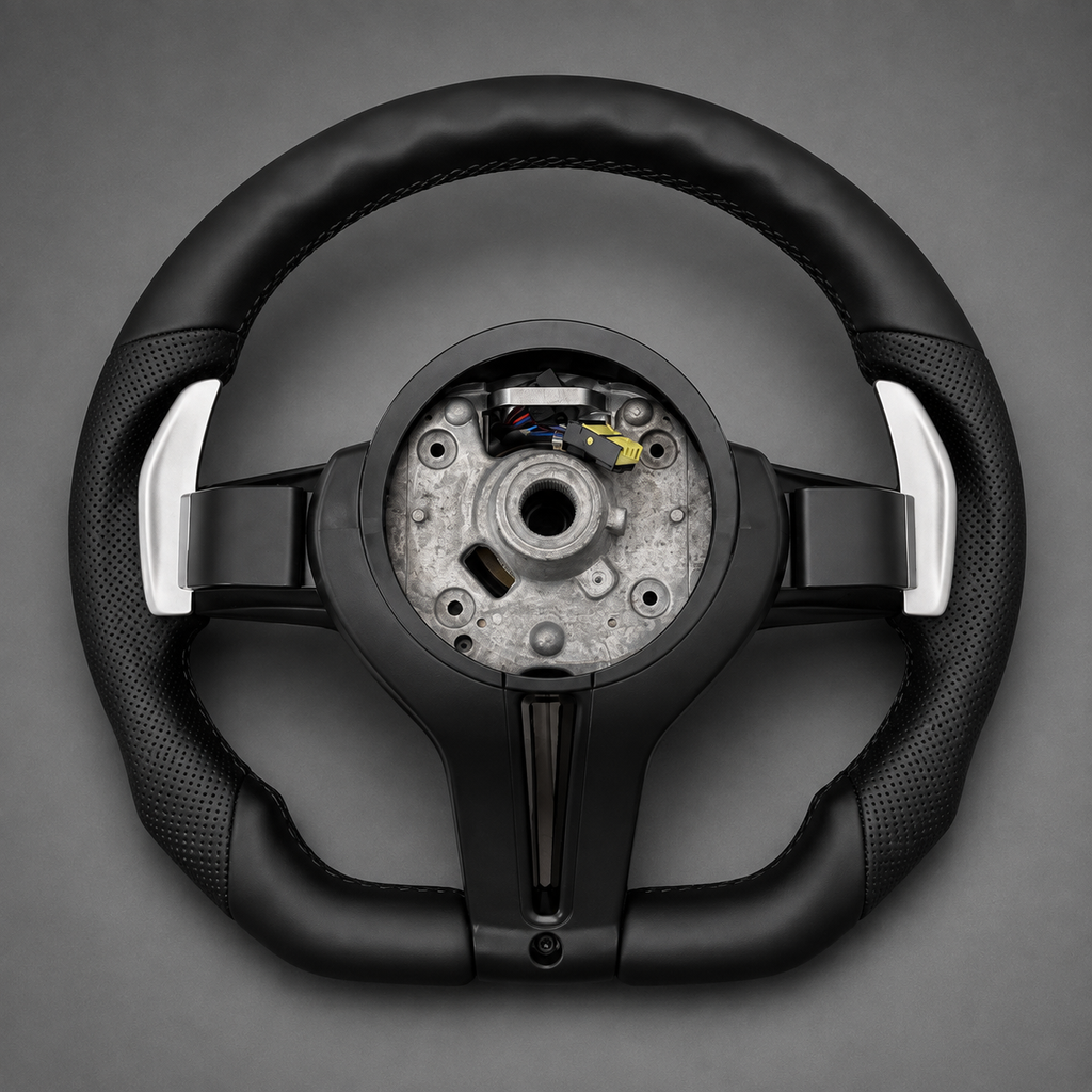 Back of BMW F Series flat bottom steering wheel with perforated leather grips and silver paddle shifters