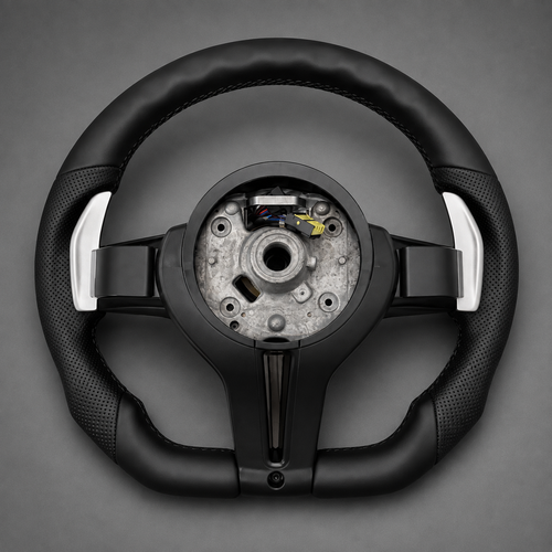 Back of BMW F Series flat bottom steering wheel with perforated leather grips and silver paddle shifters